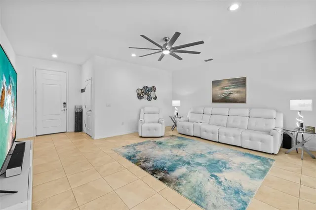 a view of a livingroom with a ceiling fan and wooden floor