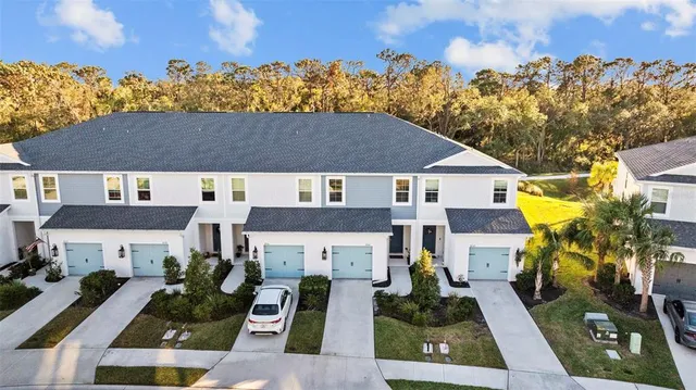 an aerial view of a house with a lake