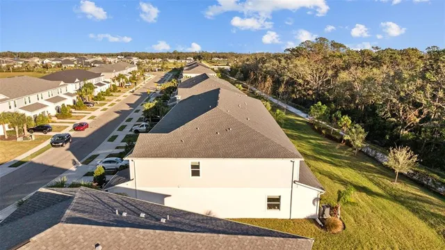 an aerial view of residential houses with outdoor space