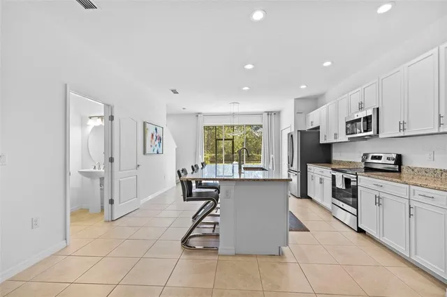 a kitchen with stainless steel appliances granite countertop a stove oven and a refrigerator