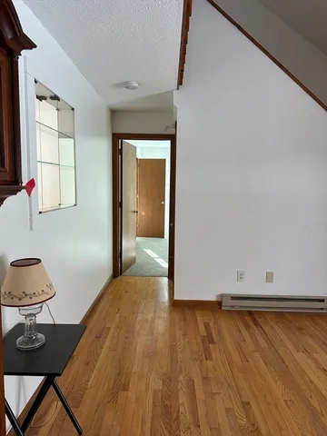 a view of a room with wooden floor and chair