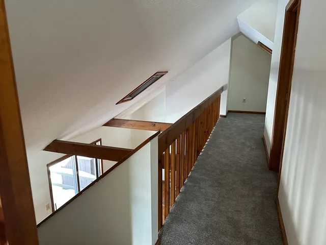 a view of a hallway with stairs