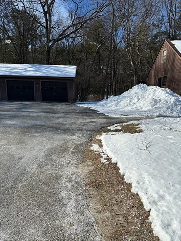 a view of house with snow on the road