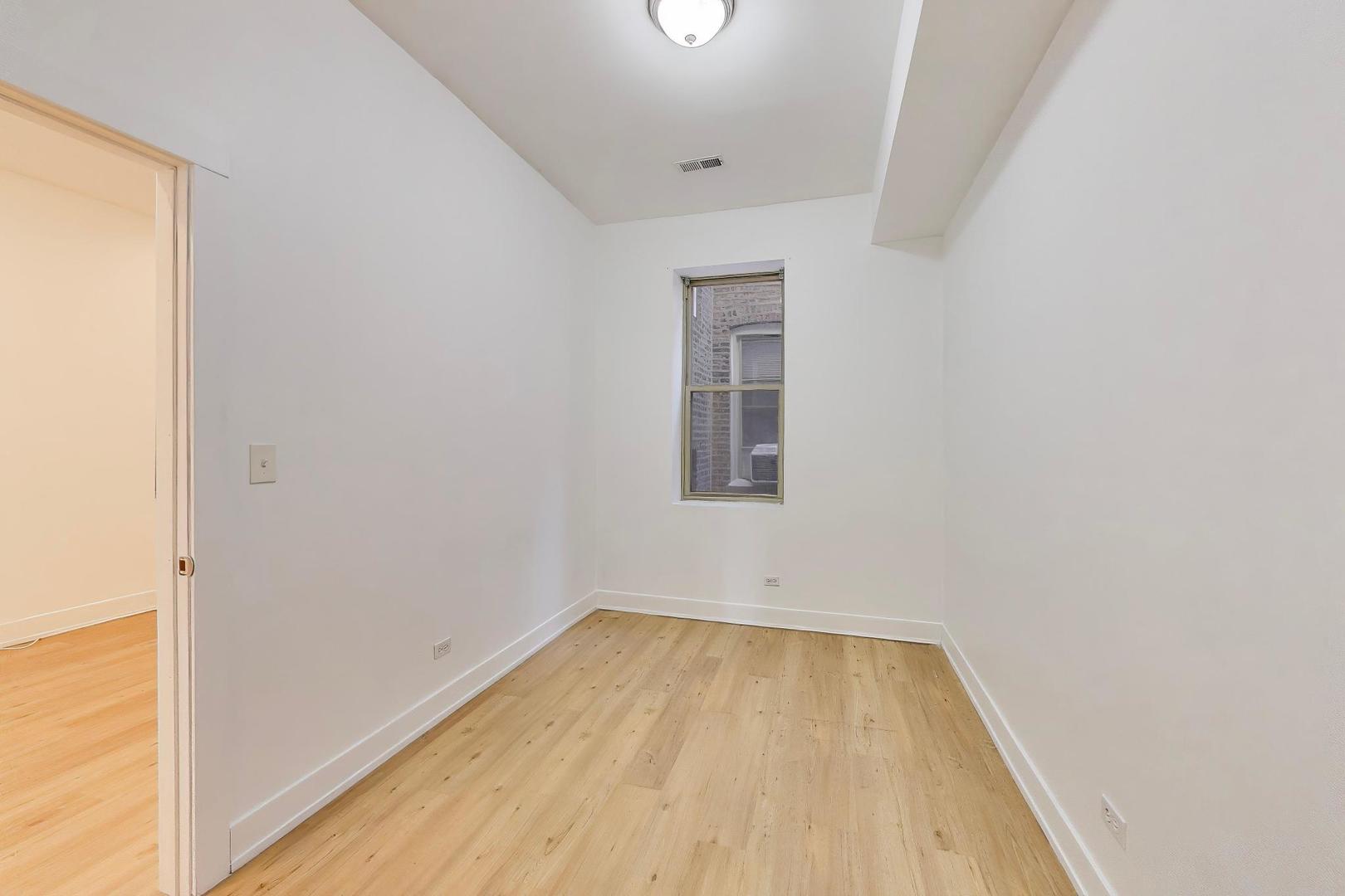 1908 West 48th Street, Unit 1R Chicago, IL 60609 - Photo 11 of 17 a view of a room with wooden floor and a window
