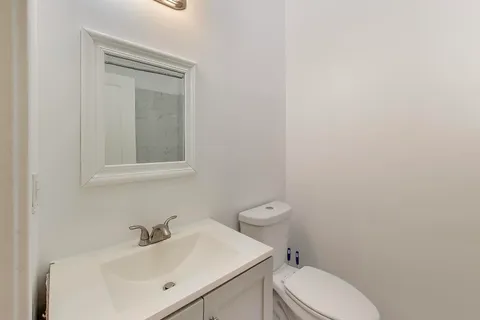 a white toilet sitting next to a bathroom sink