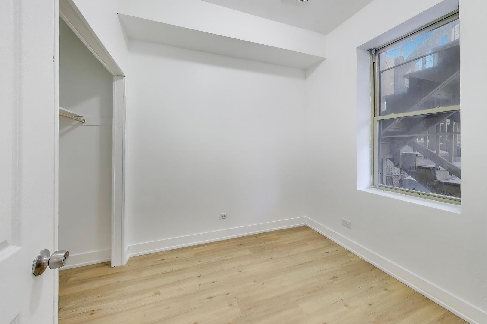 1908 West 48th Street, Unit 1R Chicago, IL 60609 - Photo 15 of 17 an empty room with a door