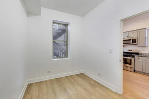 a view of a kitchen with wooden floor and a sink