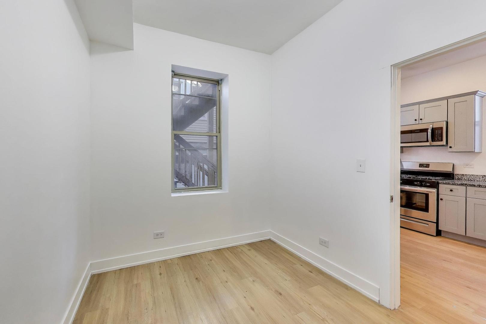 1908 West 48th Street, Unit 1R Chicago, IL 60609 - Photo 4 of 17 a view of a kitchen with wooden floor and a sink