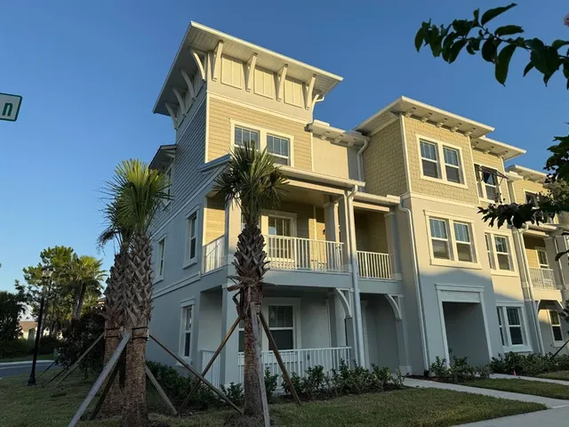 a front view of a residential apartment building with a yard
