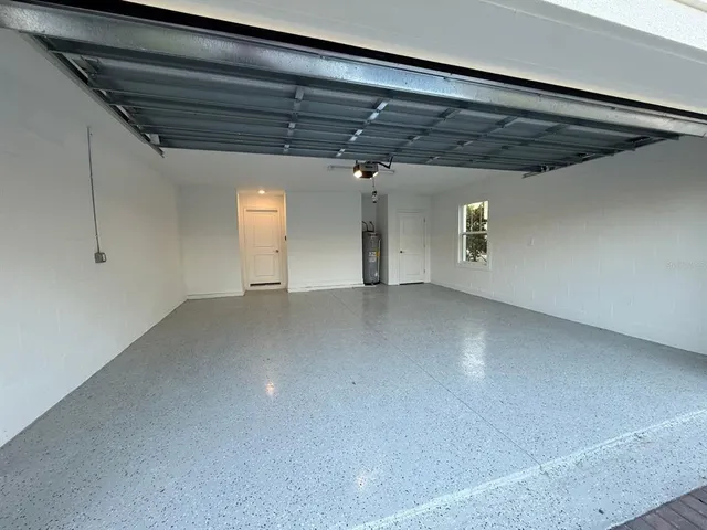 an empty room with closet and a window