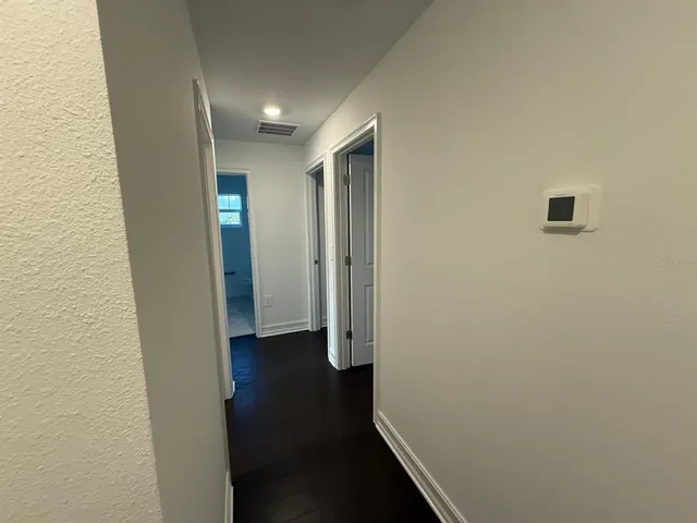 an empty room with wooden floor