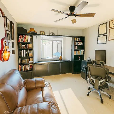 a livingroom with workspace and a couch