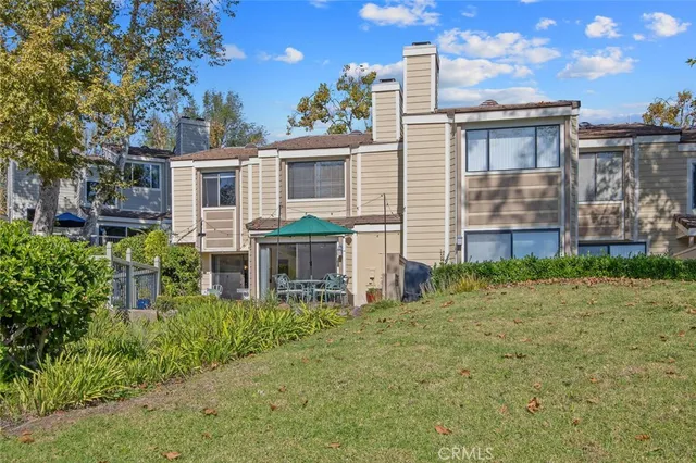 a backyard of a house with table and chairs