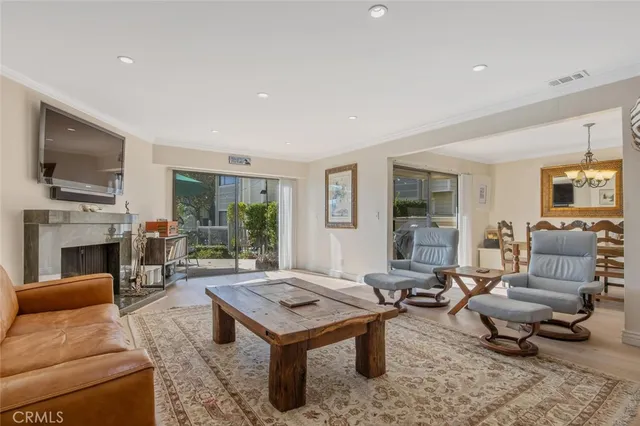 a living room with furniture a fireplace a flat screen tv and a fireplace