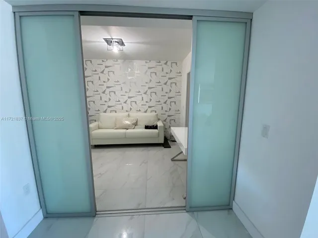 a view of a roof deck with table and chairs