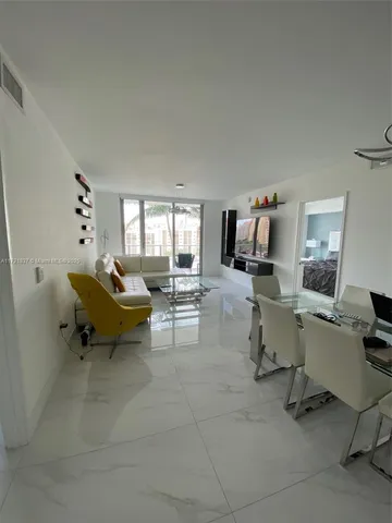 a bedroom with a bed and a flat tv screen on the dresser
