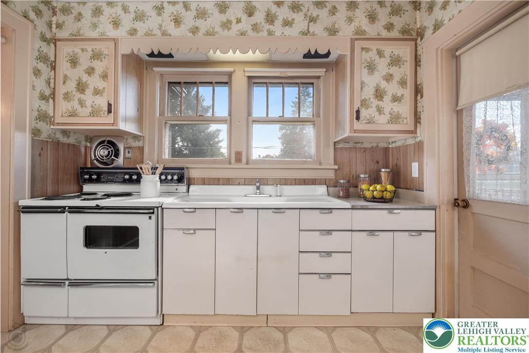 2730 Farmersville Road Bethlehem, PA 18020 - Photo 14 of 24 a kitchen with stainless steel appliances a stove a sink and white cabinets
