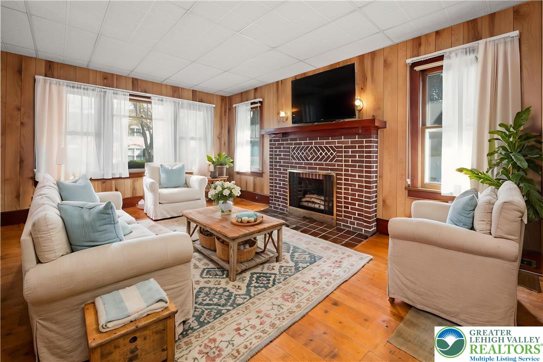 2730 Farmersville Road Bethlehem, PA 18020 - Photo 9 of 24 a living room with furniture a flat screen tv and a fireplace