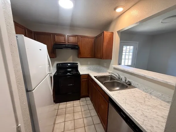 a kitchen with a sink a stove and refrigerator
