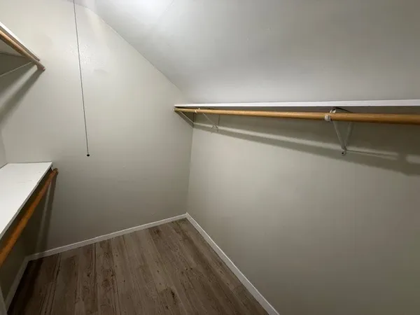 a view of a room with wooden floor