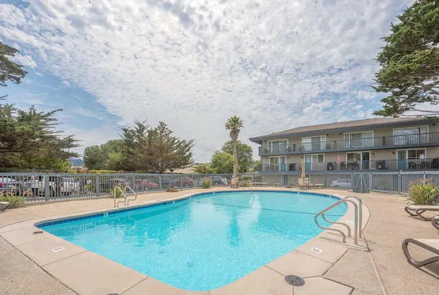 a view of a swimming pool with a yard