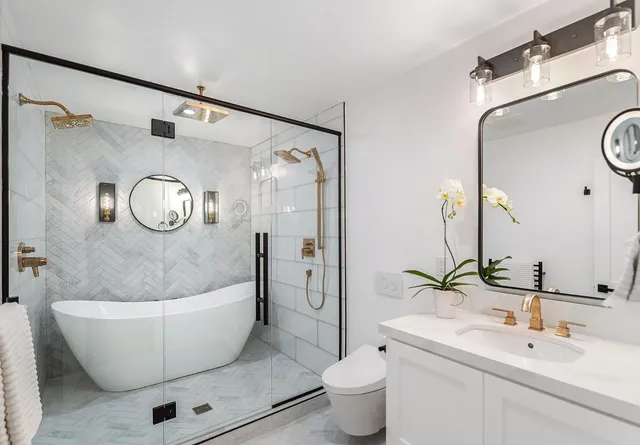 a bathroom with a toilet a sink and a mirror