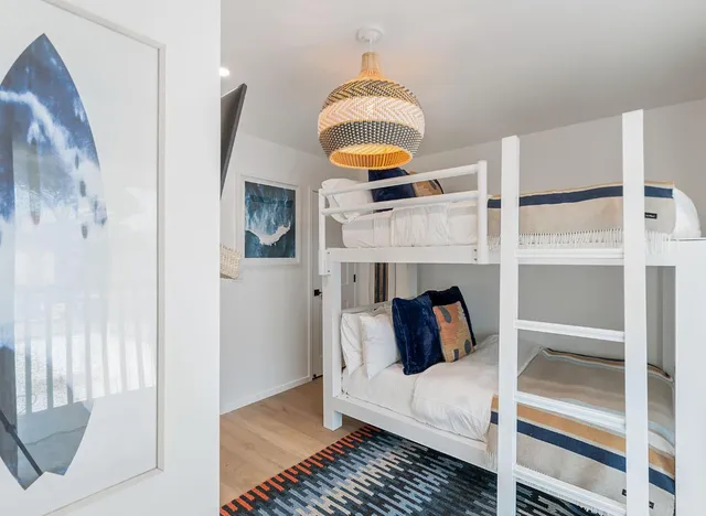 a bedroom with a bed and a painting on the wall