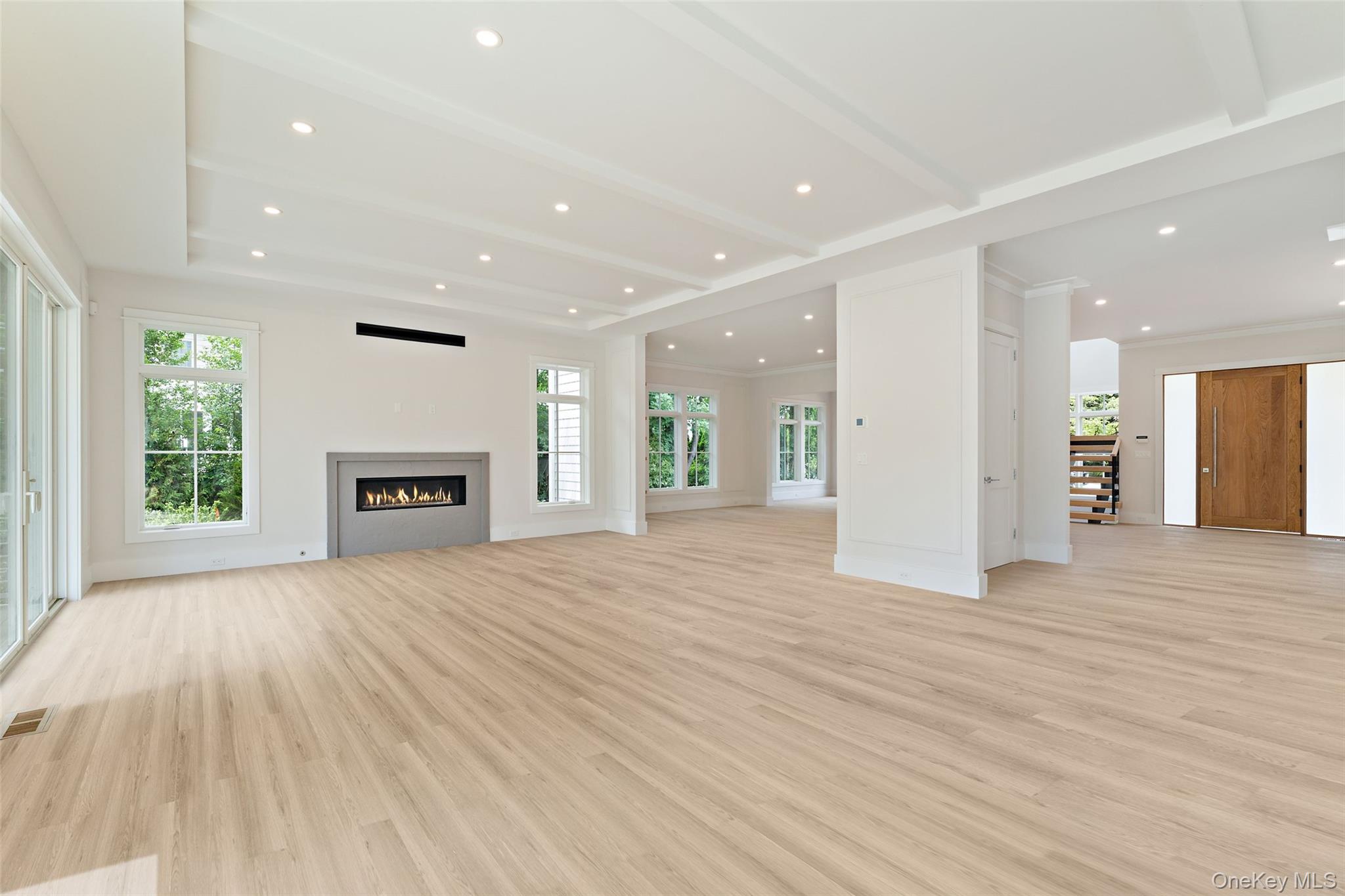 101 Carthage Road Scarsdale, NY 10583 - Photo 11 of 35 an empty room with wooden floor fireplace and windows