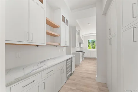 a view of a kitchen with white cabinets