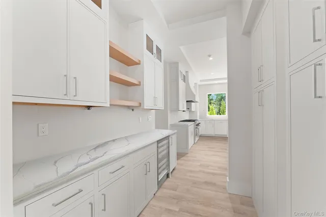 a view of a kitchen with white cabinets