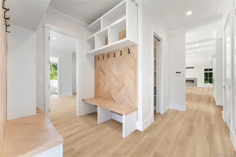 a view of an entryway with wooden floor and a bathroom