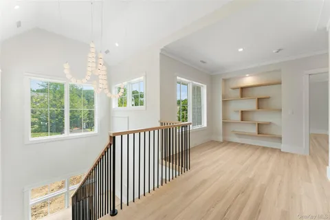 a view of a room with wooden floor staircase and windows