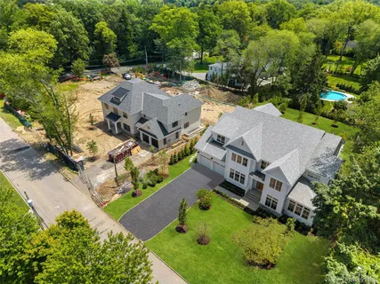 an aerial view of a house with a garden and mountain view