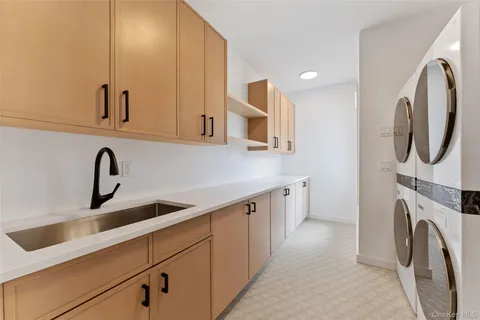a view of a kitchen with sink dryer and washer