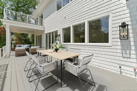 a view of a patio with table and chairs and potted plants