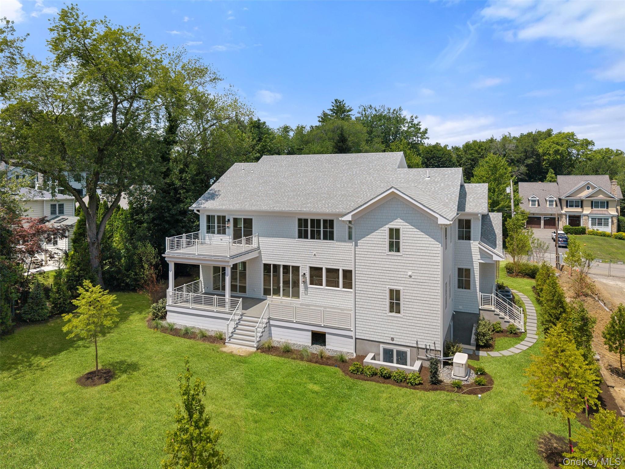 101 Carthage Road Scarsdale, NY 10583 - Photo 3 of 35 a aerial view of a house with a yard table and chairs