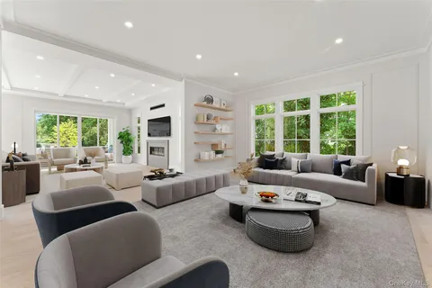 a living room with furniture and large windows