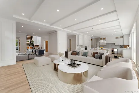 a living room with couches and kitchen view