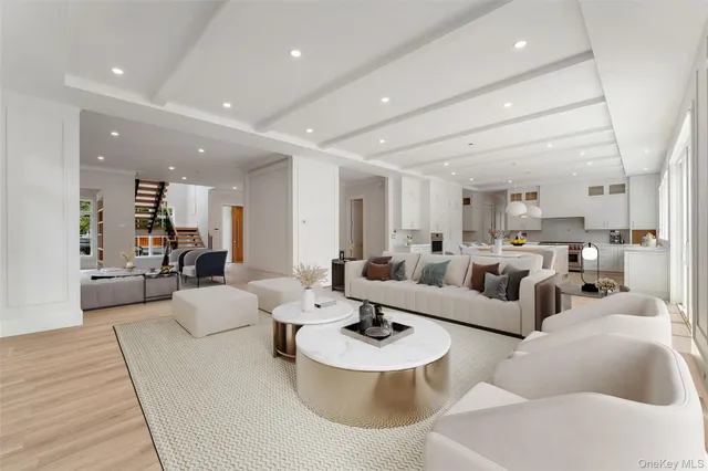 a living room with couches and kitchen view