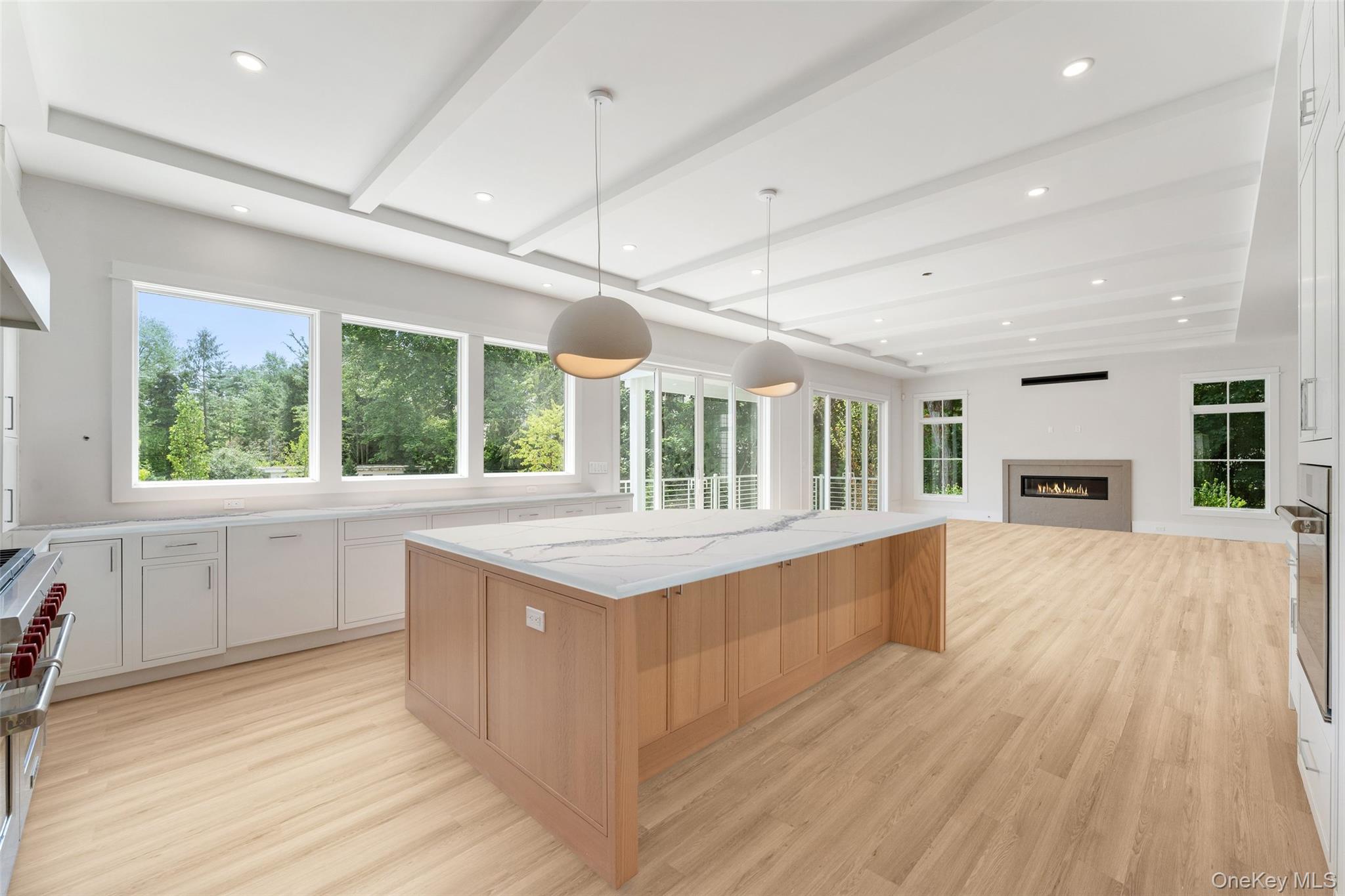 101 Carthage Road Scarsdale, NY 10583 - Photo 8 of 35 a large kitchen with kitchen island granite countertop a stove top oven a sink dishwasher a dining table and chairs with wooden floor