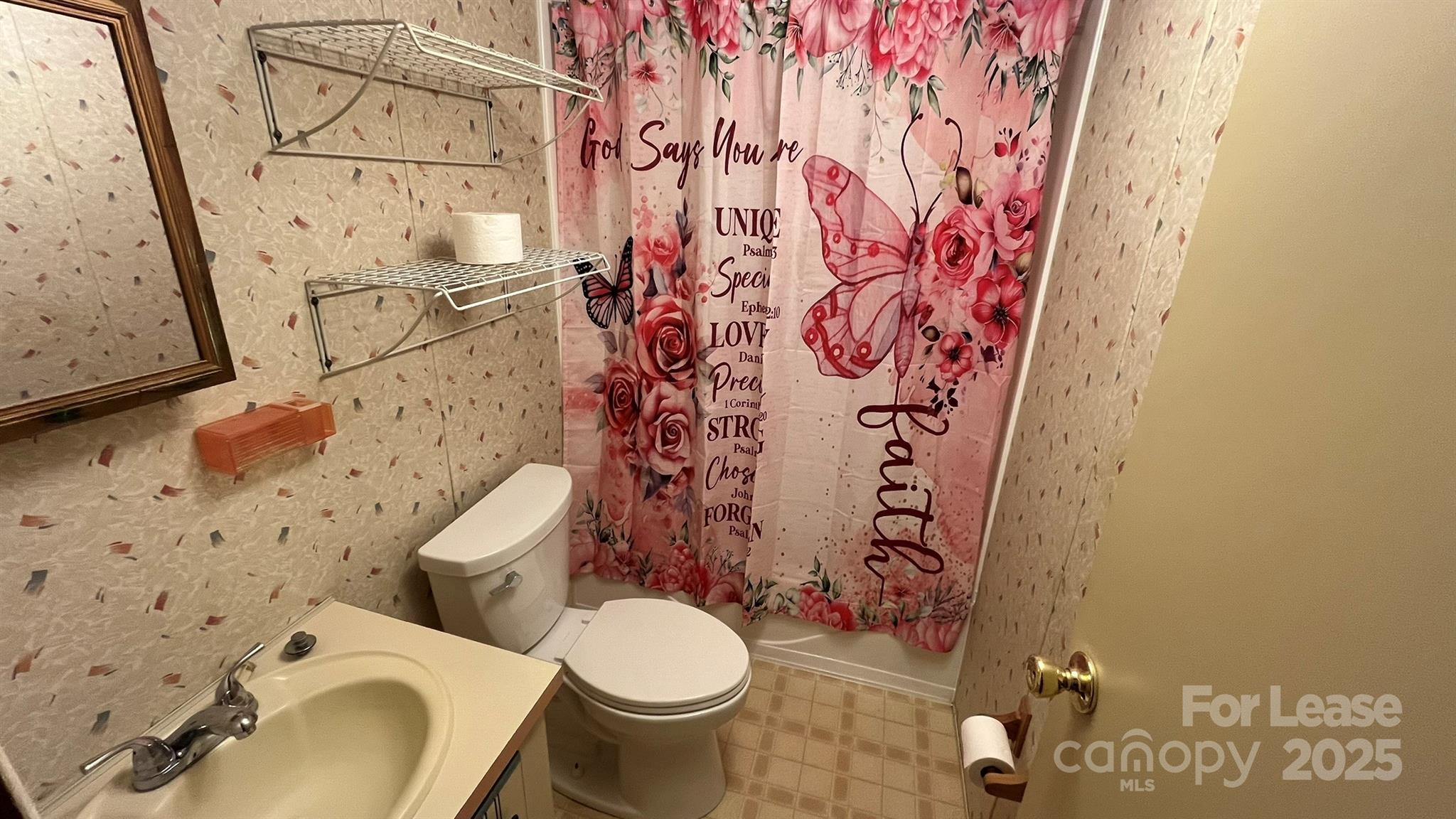 4232 Sunrise Drive Kannapolis, NC 28083 - Photo 5 of 8 a white toilet sitting next to a shower curtain