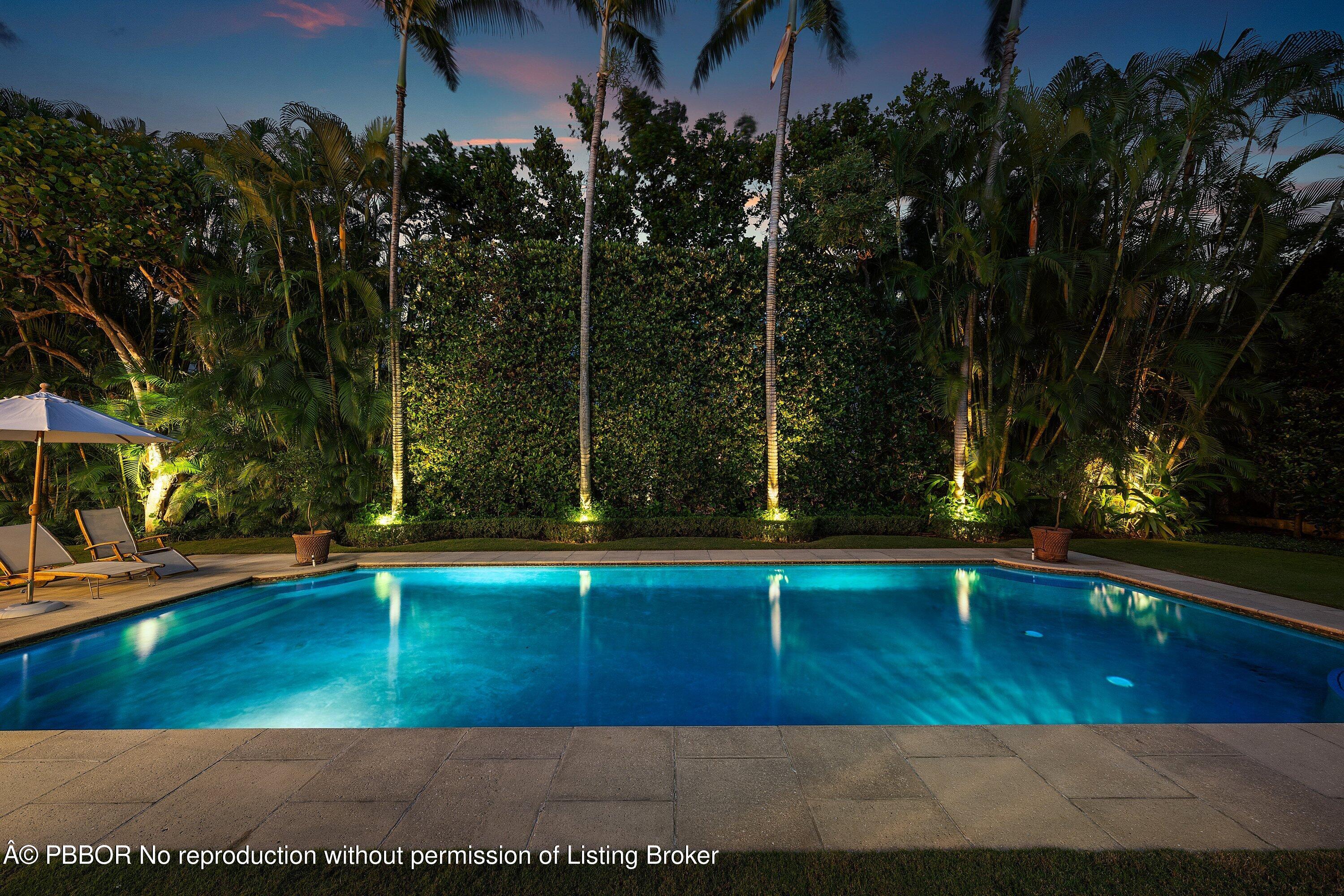 242 Wells Road Palm Beach, FL 33480 - Photo 52 of 54 a view of a swimming pool with an outdoor space and seating area