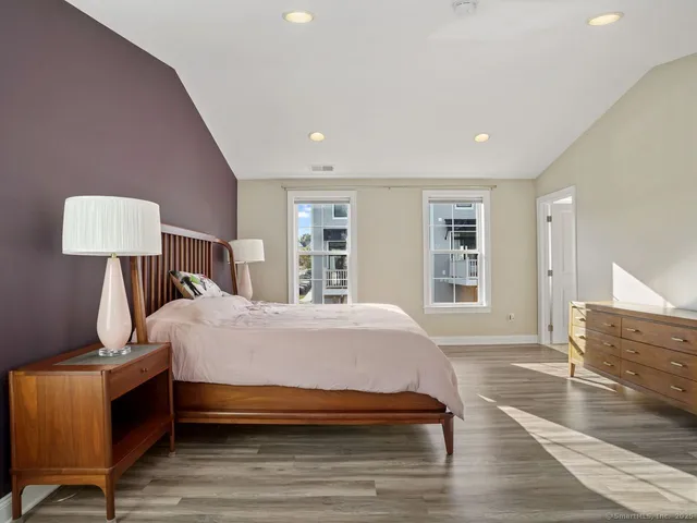 a bed room with a bed window and a chair