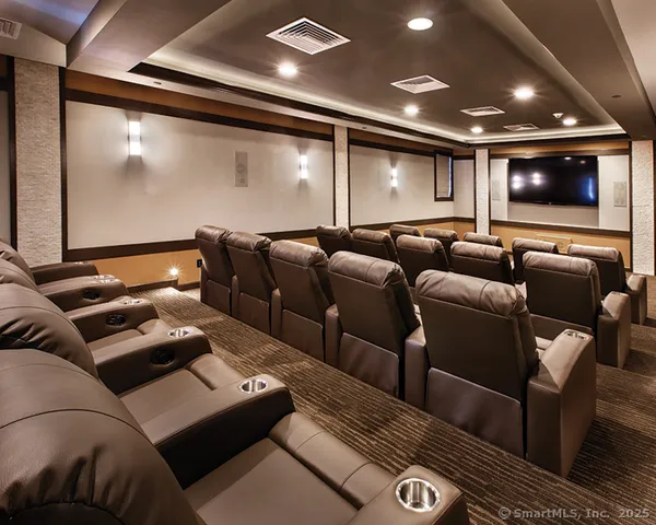 a media room with lots of chairs and a projector screen