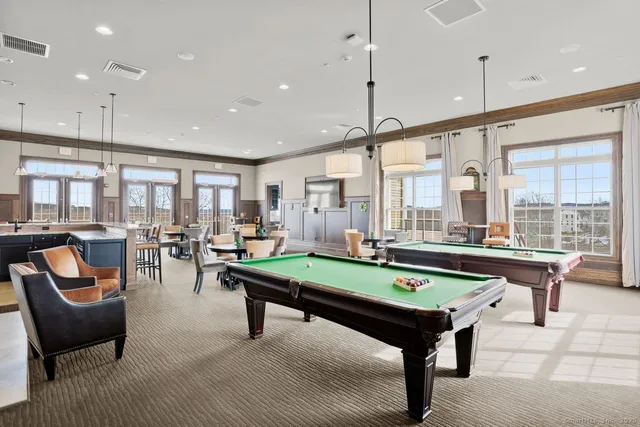 a room with pool table and windows