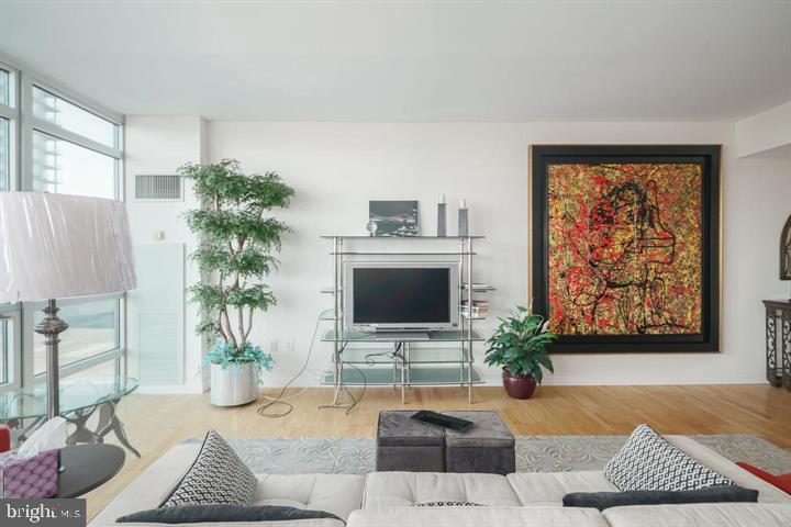 901 North Penn Street, Unit R903 Philadelphia, PA 19123 - Photo 4 of 9 a living room with furniture and a flat screen tv