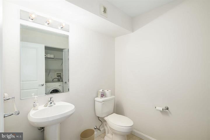 901 North Penn Street, Unit R903 Philadelphia, PA 19123 - Photo 7 of 9 a bathroom with a sink mirror and toilet
