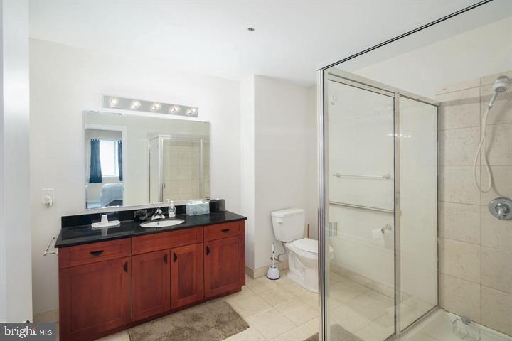 901 North Penn Street, Unit R903 Philadelphia, PA 19123 - Photo 9 of 9 a spacious bathroom with a mirror a shower and a sink