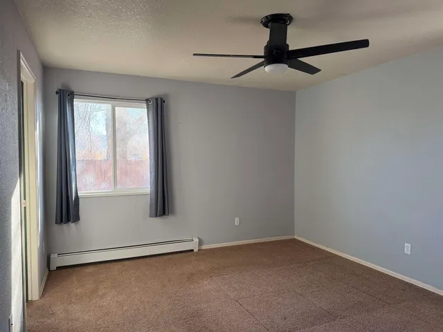 a view of an empty room and a window