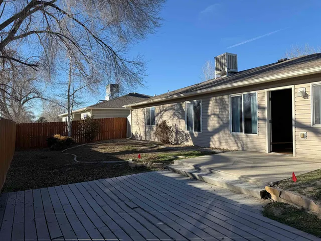a view of house with backyard porch and sitting area